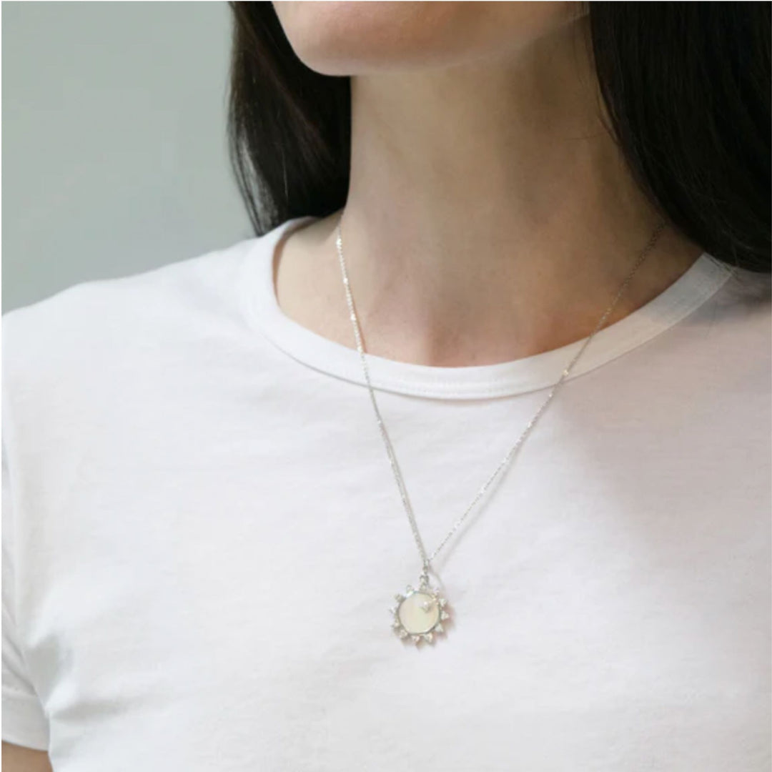 S/S MOP SUN CHARM WITH WHITE SAPPHIRES