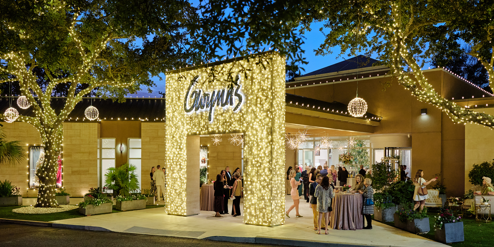 Outdoor holiday event at a venue with a prominent sign