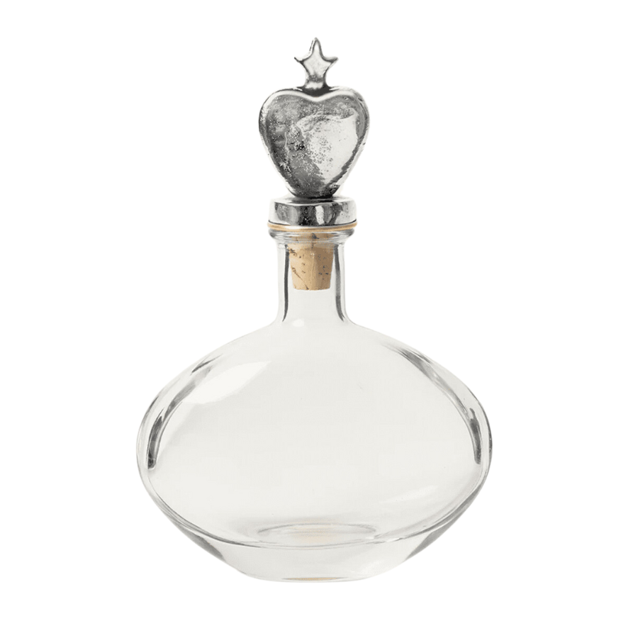 The Jan Barboglio Sagrado Corazon Decanter features a German nickel-plated heart atop a crystal clear decanter. Made of glass and iron Care: Clean with a soft dry cloth. Dimensions: 8” x 3” x 12”.